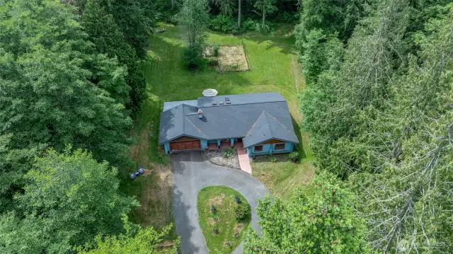Circle drive (looks more like an avocado) and aerial showing open garden area behind home. Southern exposure!  Solar possibilities here...?