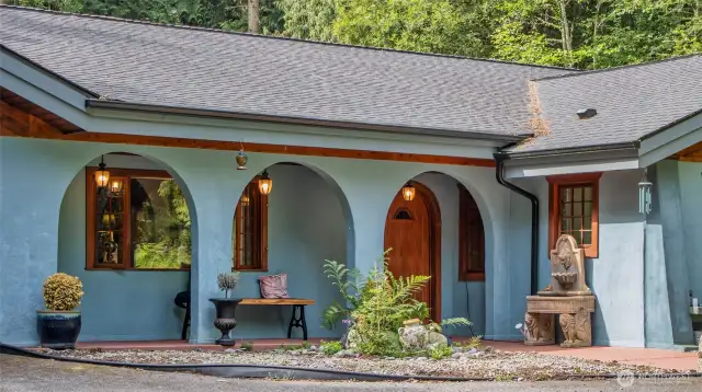 Triple arches mimic interior archways and provide a covered front entry area.