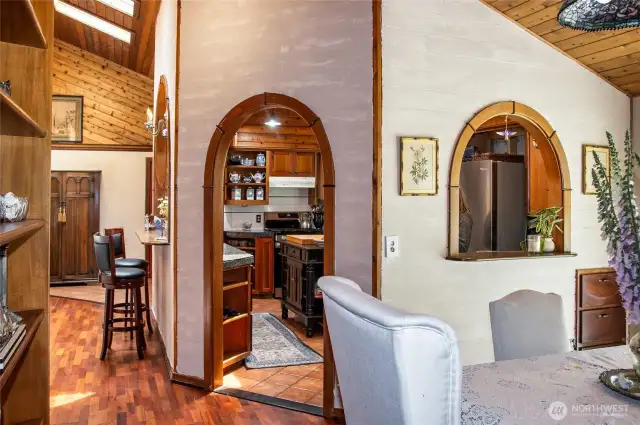 Pass through archway from kitchen to DR - Cherry and ceramic tiled floors. White-washed wood on kitchen surround