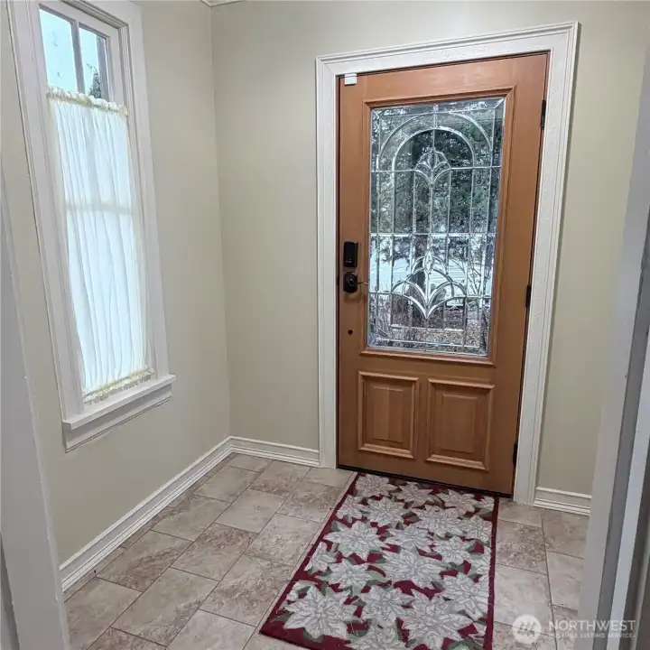 Beautiful front door. Bright entry way is spacious and has windows to the left and right.