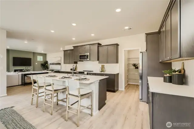 Kitchen and extra large pantry.  Photos are representation as the home is under construction.