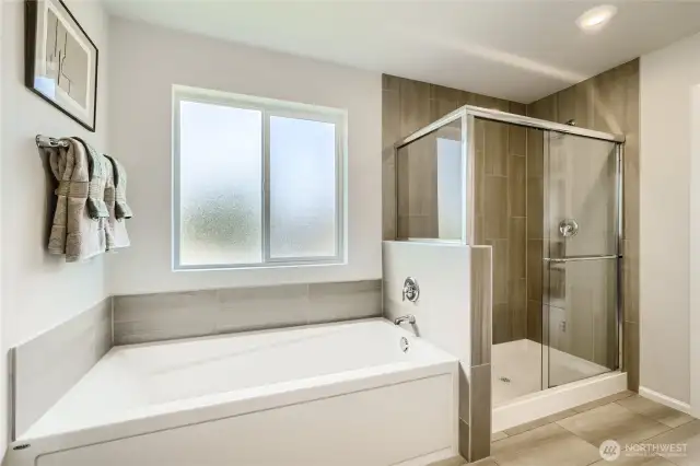 Soaking tub in primary bath  Photos are representation as the home is under construction.