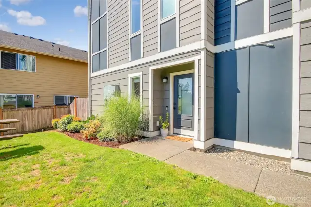 Private side entrance that borders green space.