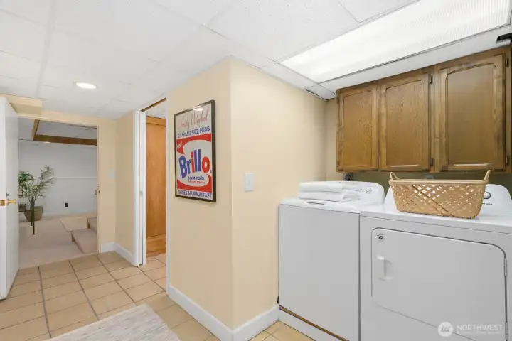 Laundry just past the bathroom. The utility room/shop has a lot of unused space (storage?). If you moved the laundry into there (pictured behind this photo), you could expand the bathroom to the laundry area.