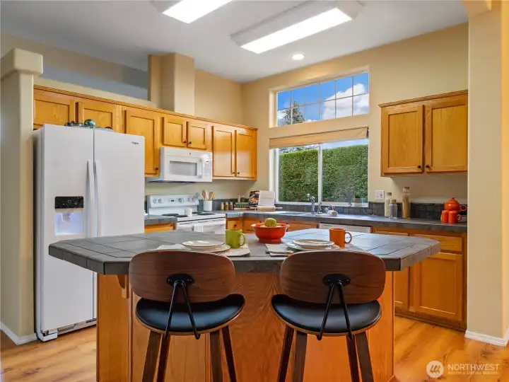 Entertain the cook  by bellying up to the island.