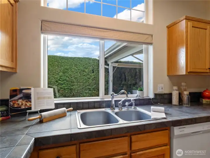 Doing dishes with a view of the side yard makes the chores feel easy.