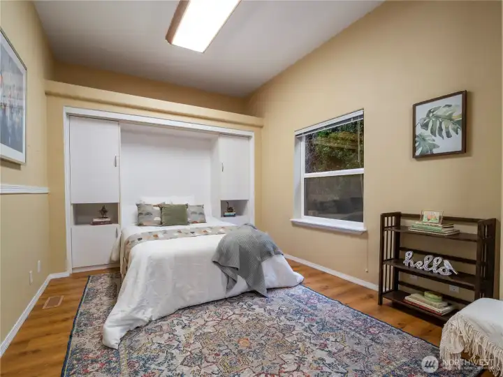 The previous owner converted two bedrooms to one large multi-purpose room. This room has a murphy bed that when not in use has a convertible fold out table and plenty of storage. If you are a crafter you will love this versitile space. Should you so desire, you could easily convert it back to two bedrooms.