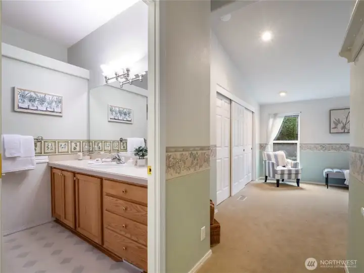 Walk in to the primary suite where the soft color pallet is conveyeing serenity.