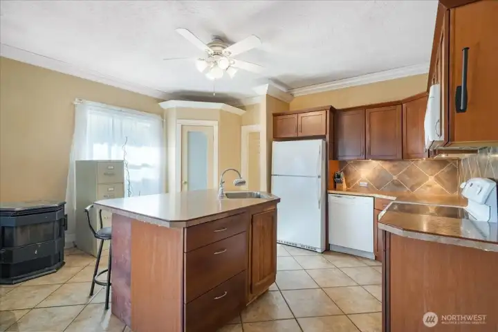The kitchen has deep countertops and an alluring backsplash all the way up to the cabinetry.