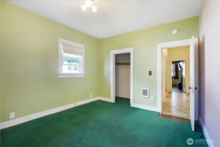 Bedroom 1 with view of closet and hallway.