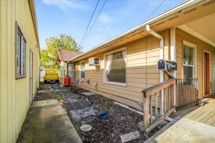 Between home and hobbies! The path between the home and the gigantic shop. Leads to the man door for the shop and the alley for even more parking!