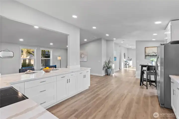 Kitchen with brand new LVP flooring, cabinets, quartz counter tops, all new appliances, new lighting throughout