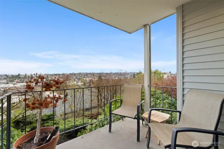 Covered balcony bliss—sip, unwind, and soak up the skyline from your private outdoor retreat.