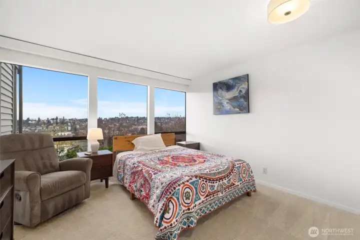 Wake up to skyline vistas and soft morning light in this inviting bedroom sanctuary.