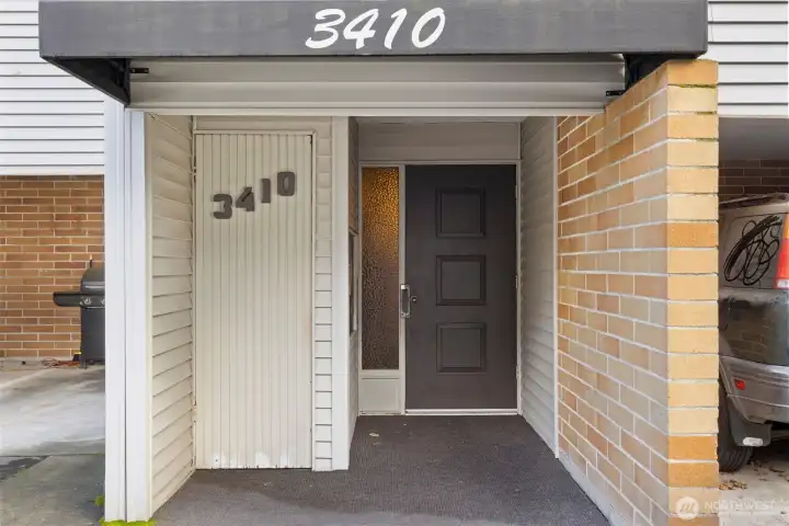 Stylish front entry with tandem-style parking located just to the left—featuring one covered space for everyday convenience.