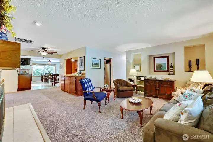 The front entry opens into the cozy living room with the kitchen and dining space beyond.
