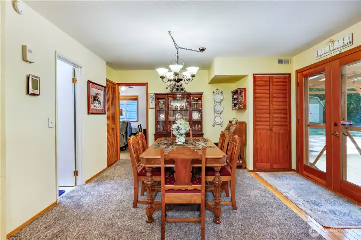 A view of the dining room with the 3/4 bath on the left and den/office through the door beyond.