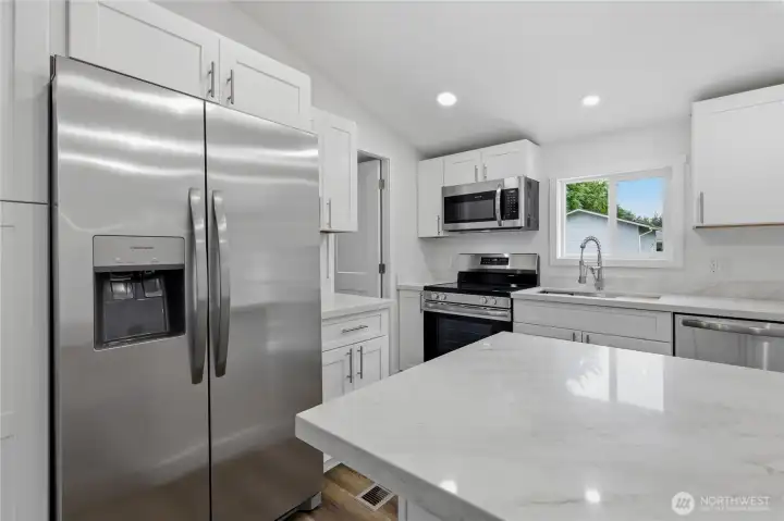 Brand new stainless steel kitchen appliances with quartz countertop