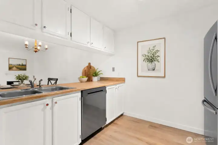 Virtually staged kitchen to dining area. Virtually staged kitchen to dining area.