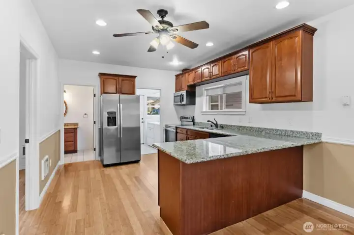 Big kitchen with plenty of cabinets, slab granite countertops and a great layout.