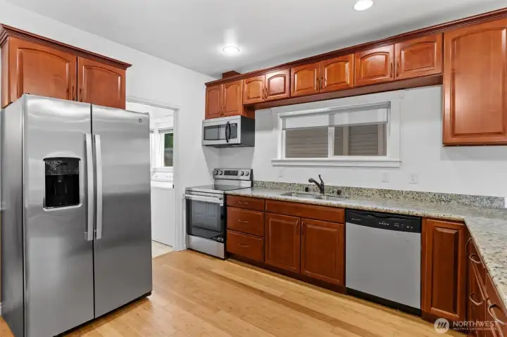 Big kitchen with plenty of cabinets, slab granite countertops and a great layout.