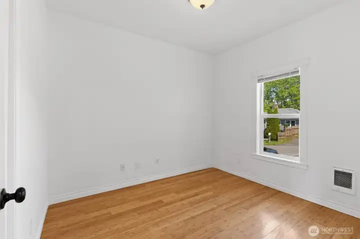 Primary bedroom with beautiful bamboo floors. This bedroom has views of the Cascade Mountains and Snohomish River.