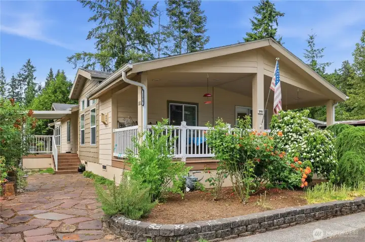 Front of home with large deck in front & another deck on the side of home.