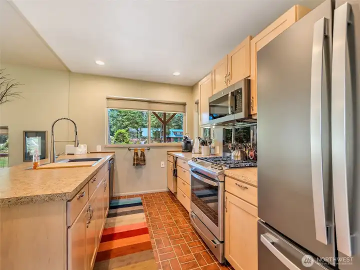 Spacious kitchen with abundant cabinetry, stainless steel appliances, and views of the backyard. Spacious kitchen with abundant cabinetry, stainless steel appliances, and views of the backyard.
