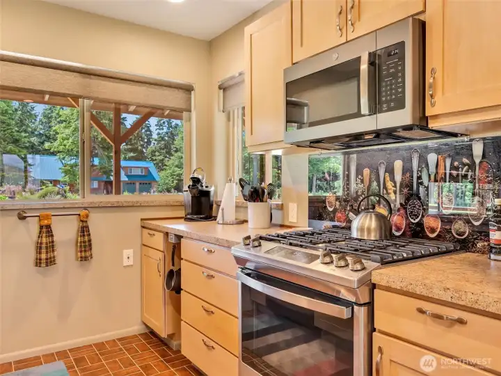 Well-equipped kitchen featuring generous prep space and breakfast bar seating. Well-equipped kitchen featuring generous prep space and breakfast bar seating.