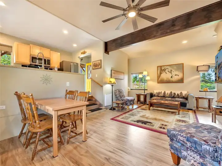Bright, open living room with vaulted ceilings and a cozy fireplace. Bright, open living room with vaulted ceilings and a cozy fireplace.