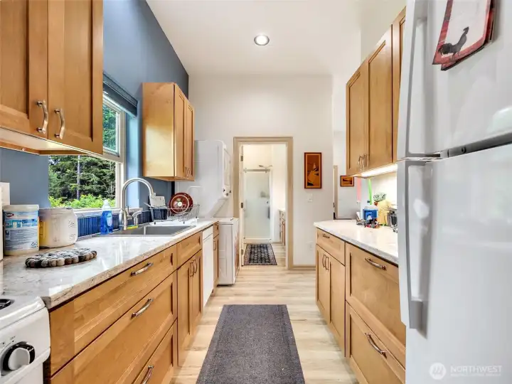 Efficient kitchen featuring abundant cabinetry and workspace. On demand water heater is located above the stove in the cabinet. Efficient kitchen featuring abundant cabinetry and workspace. On demand water heater is located above the stove in the cabinet.