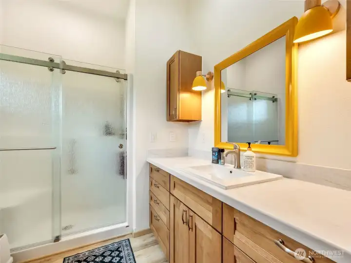 Full bathroom with walk-in shower and updated vanity. Full bathroom with walk-in shower and updated vanity.