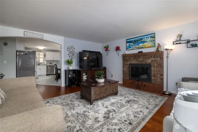 Large living room with warm wood fireplace