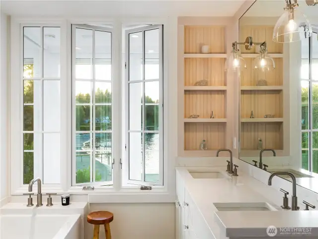 The primary bathroom with views out to the sound. Brilliant design with interior windows.
