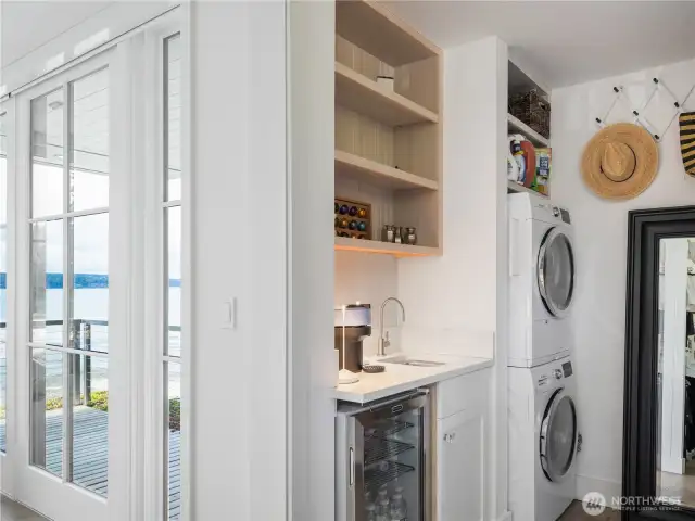 The walk-in closet is an organizer’s dream with its own washer and dryer—plus a coffee bar with a filtered water dispenser and a drink fridge.