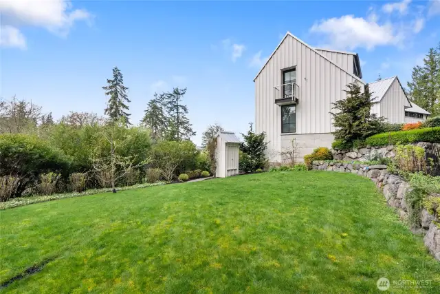 Varied landscaping includes a beautiful, lush lawn. The balcony is off the 2nd primary suite.
