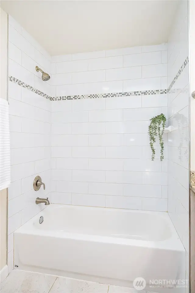 Upstairs Main Bathroom has a full tub with tile.