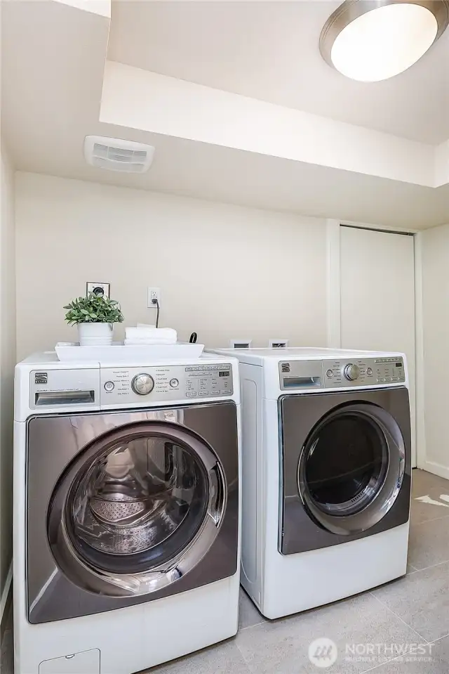 Full-sized washer dryer. This is in its own room, separate from the downstairs living area. Water heater and new furnace are in the room behind.