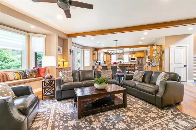 Great room concept with spacious living. Custom window seat to left of frame.