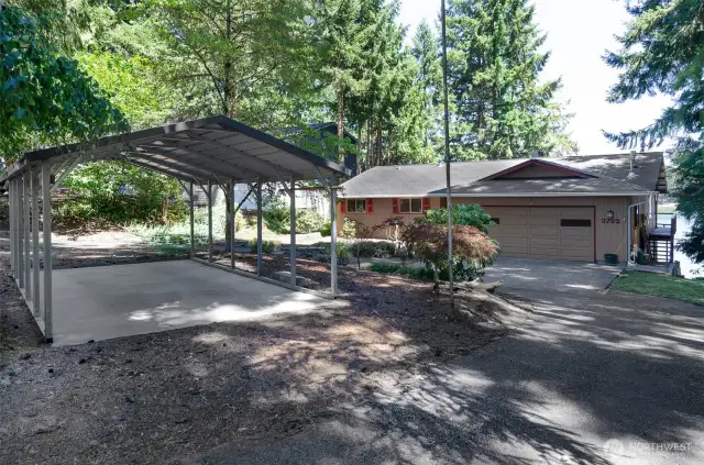 The front view from Long Lake Dr. showcases the carport , driveway and garage for plenty parking