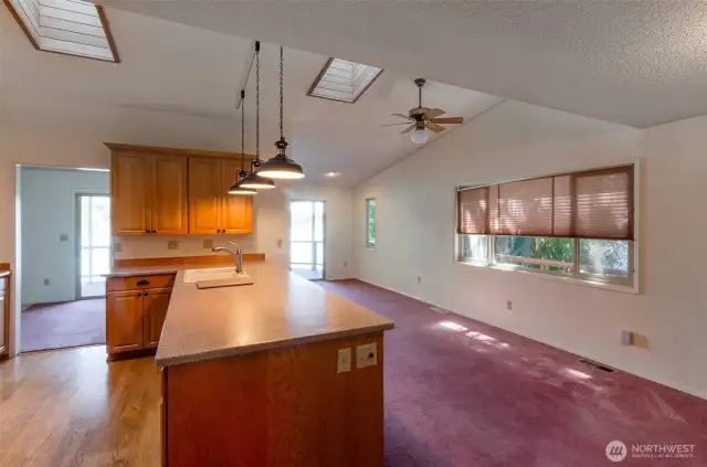 The kitchen on the main level with hardwood floors , tons of storage and other potential ready for your imagination.