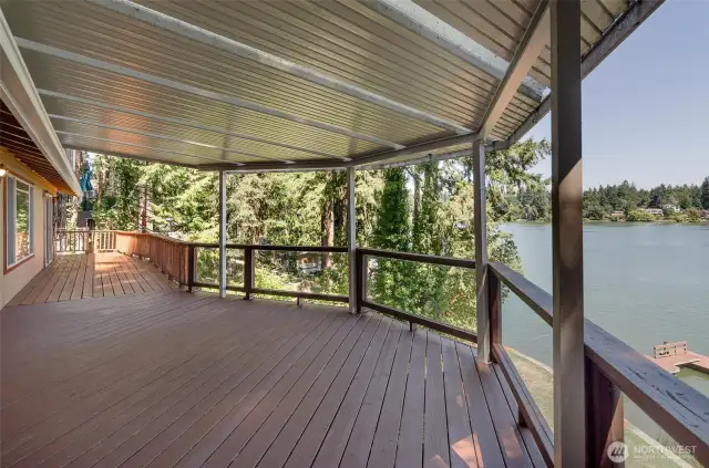 The main level deck runs from the dining/living all the way to the primary suite with access from both areas.