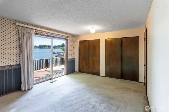 Primary Bedroom - sliding glass doors lead to the deck. The bedroom easily fits a king size bed.