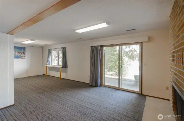 Basement without the furnishings. The sliding glass door leads you to an outdoor patio.