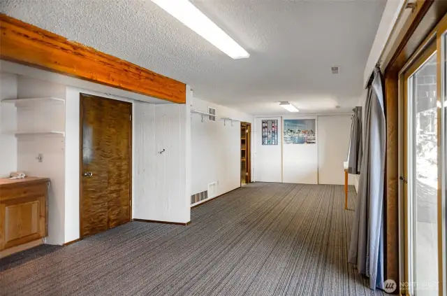 Another view of the basement without the furnishings. Note the utility room is tucked away here as well as a workshop.