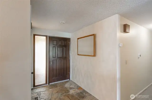 Interior view of the front door designed from solid wood and entryway.