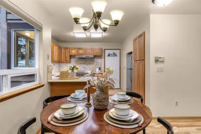 Cozy and intimate, the dining nook is perfect for everyday meals or evening dinners under soft pendant lighting. The window frames the natural beauty just outside.