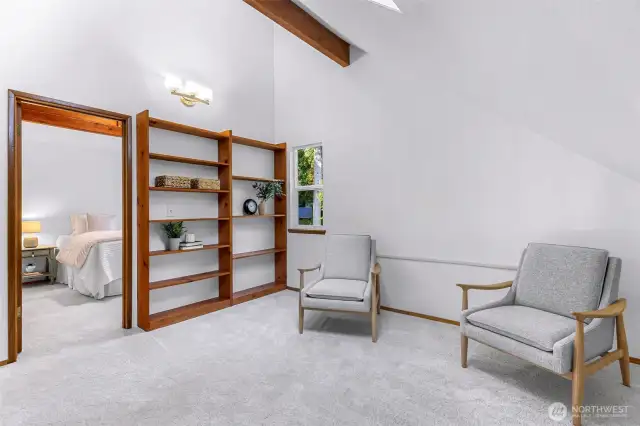 This upstairs flex space offers endless potential—create a reading nook, meditation area, or home office beneath vaulted ceilings and warm natural light. Built-in shelving adds charm and storage.