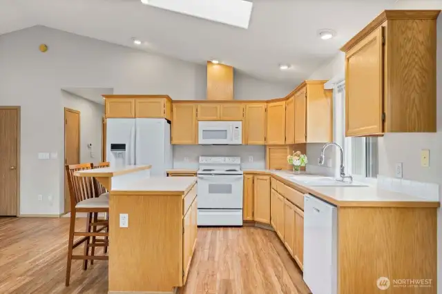 Walk around kitchen island with plenty of cabinets.