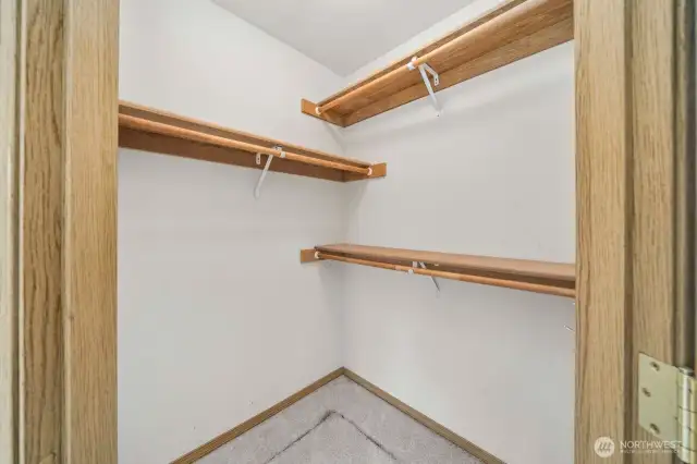 Walk in closet with shelving in primary bedroom